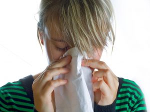 woman-blows-nose-in-kleenex