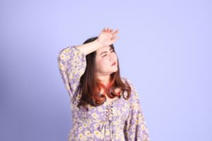 asian-woman-sweating-against-purple-background