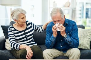 senior-woman-pats-senior-man-on-shoulder-he-is-sick