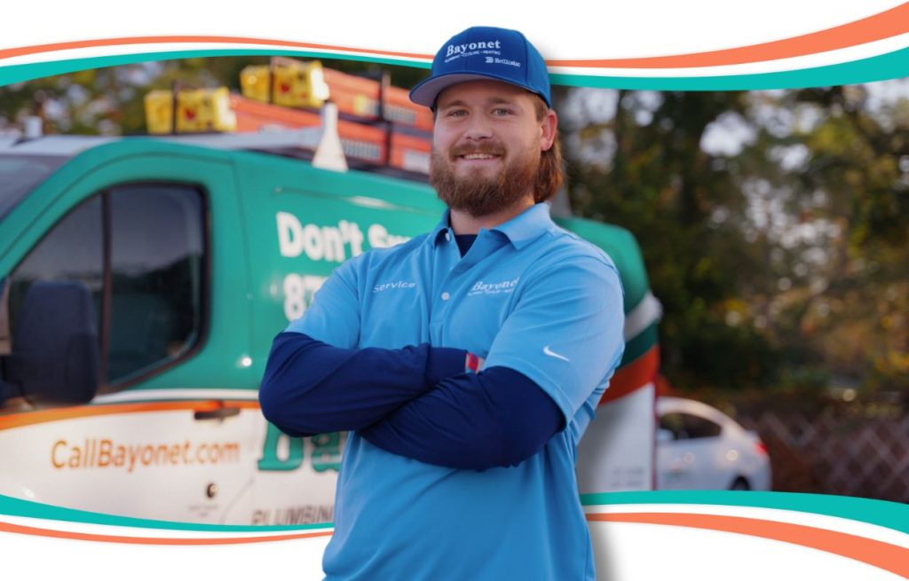 This is an image of a Barnett HVAC technician standing in front of his van.