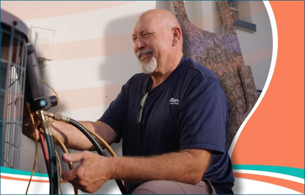 This is an image of an Bayonet HVAC tech working on an AC unit.