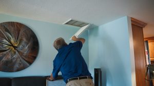 technician-assesses-vent-in-ceiling