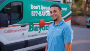 Bayonet-tech-wearing-blue-shirt-in-front-of-Bayonet-van
